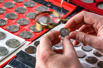 Numismatics.Authentic silver denarius, antoninianus of ancient Rome. A collector holds an old...