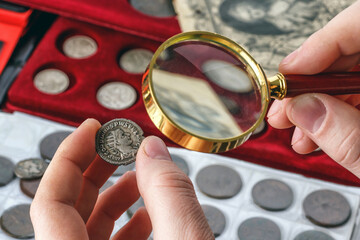 Numismatics.Authentic silver denarius, antoninianus of ancient Rome. A collector holds an old...