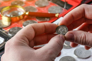 Numismatics.Authentic silver denarius, antoninianus of ancient Rome. A collector holds an old...