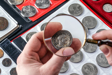 Numismatics.Authentic silver denarius, antoninianus of ancient Rome. A collector holds an old...