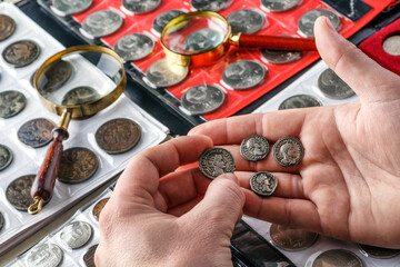 Numismatics.Authentic silver denarius, antoninianus of ancient Rome. A collector holds an old...