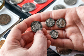 Numismatics.Authentic silver denarius, antoninianus of ancient Rome. A collector holds an old...
