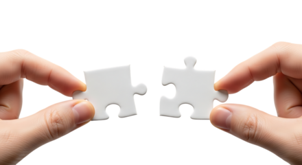 Two puzzle pieces held by hands ready to be connected