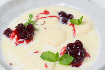 Syrniki in milk-vanilla sauce with cherry jam and mint