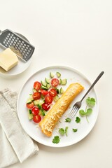 Delicious french omelette with cheese served with fresh vegetables