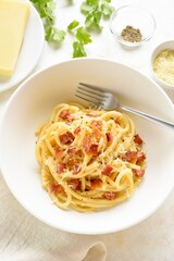 Italian pasta dish with crisp pancetta, parmesan cheese and black pepper