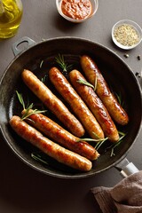 Thin sausages in frying pan