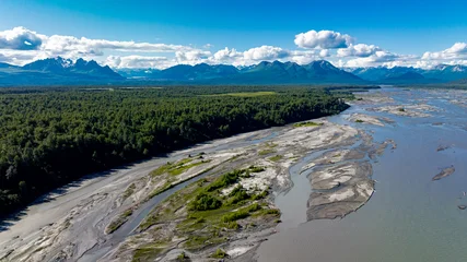 Fototapete Rund Wald Fluss Forest and braided river under Alaskan sky. Aerial view of Alaskan forest and braided river flowing through wilderness toward distant mountains.  © Vadim