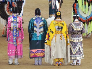 Four ladies all lined up at the pow wow