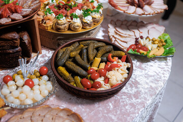 Festive table spread with assorted appetizers and pickled vegetables in a cozy setting