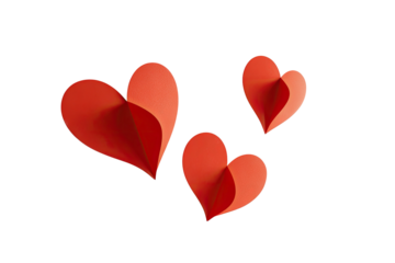 Three folded paper hearts in shades of red on a black background