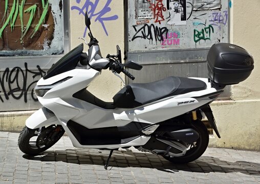 White Honda PCX scooter parked on urban street