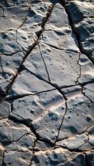 Close-up View of a Cracked Rock Surface with Unique Textures and Patterns