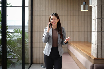 Businesswoman standing talking on the phone and making gestures