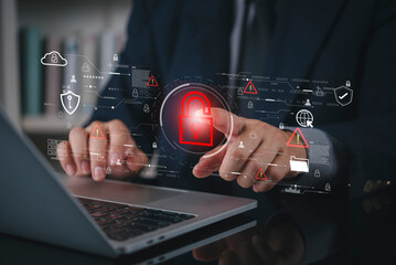 Businessman hand using laptop with virtual padlock icon for cybersecurity data protection. Network security system technology for business internet privacy and protect information access concept.