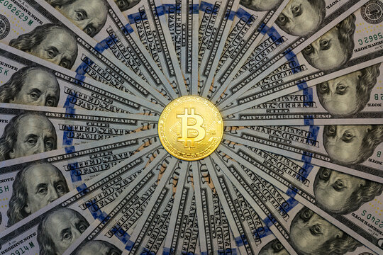 Gold bitcoin with a portrait of Benjamin Franklin from American dollars. Bitcoin BTC virtual money and US dollar banknotes. Background with bitcoin cryptocurrency coins and US dollar.