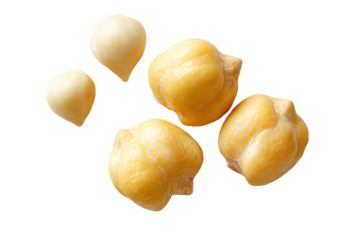 Close-up of several pale yellow, smooth chickpeas, isolated against a black background
