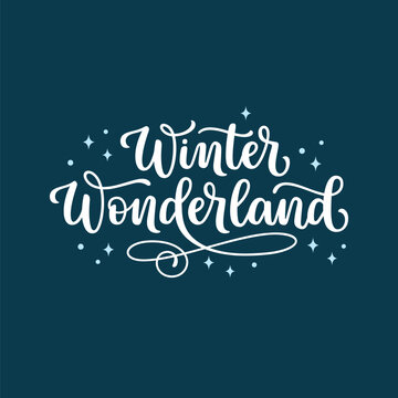 Winter wonderland hand lettered phrase over navy blue sparkling background