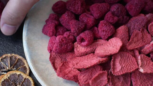 Dried sublimated slices of strawberry as an ingredient for sweet desserts. Dried strawberry and raspberry as a food background for your design