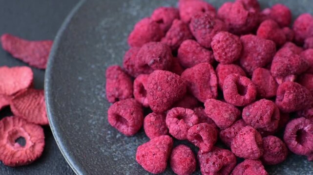 Dried sublimated slices of raspberry as an ingredient for sweet desserts. Dried raspberry as a food background for your design