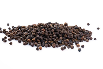 Black peppercorns on white background