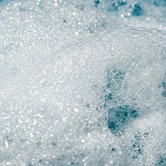 Close-up of effervescent white foam and shimmering water. Abstract texture of cleansing bubbles for hygiene and freshness ,tranquil ,routine ,wash