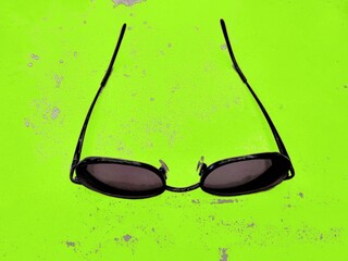 sunglasses on green background