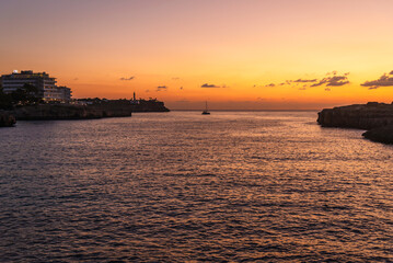 The rocky shores of Cala Mar&ccedil;al in the light of the setting sun