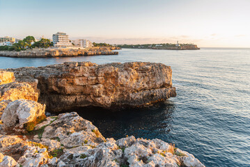 The rocky shores of Cala Mar&ccedil;al in the light of the setting sun