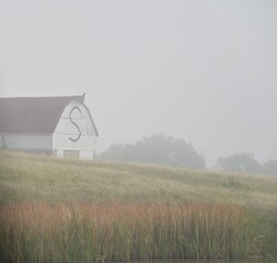 Fototapeta premium Old Barn in a Foggy Field