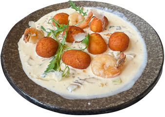 Creamy gnocchi dish with shrimp and arugula topping