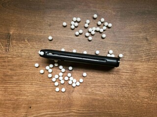 Airsoft magazine with BBs. Though just an airsoft replica, the photo showcases the weapon's beauty,...