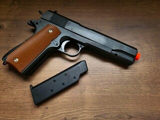Plastic gun with spare cartridge. Though just an airsoft replica, the photo showcases the weapon's...