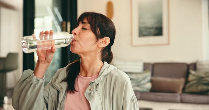 Fitness, drink water and woman in living room, indoor activity and exercise for thirst. Hydration, workout routine or mature person relax with liquid in home, break or rest for practice completion