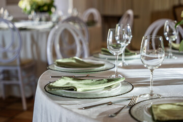 Elegant wedding banquet hall table setting features decorative glassware, fine linens, and stylish tableware, creating a sophisticated dining atmosphere