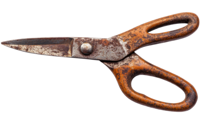 Rusted metal scissors with orange handles on black background, angled view
