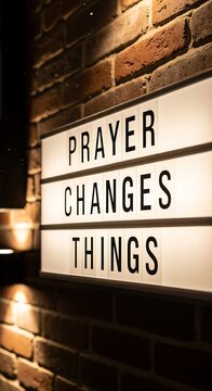 Illuminated sign displaying the message Prayer Changes Things.