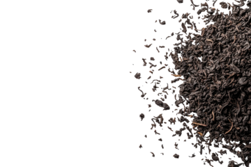 Dark, dry tea leaves scattered on the right over a stark black background