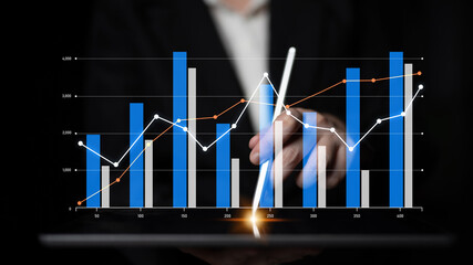 A business professional analyzes financial data using colorful graphs on a digital tablet, representing growth and performance metrics in a corporate setting. Scalp