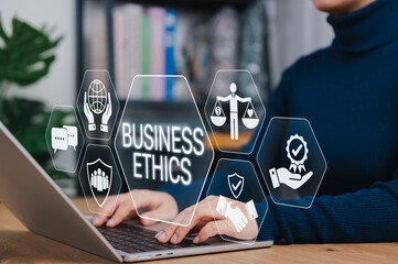 Business ethics concept. Person using laptop with digital icons of trust, balance, responsibility, representing corporate integrity, transparency and moral principles in modern business. core values,