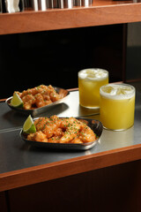 Crispy Shrimp Appetizers and Yellow Cocktail