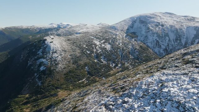 Experience serene snowy mountains with majestic peaks and lush trees