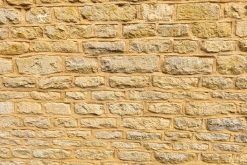 Ancient weathered stone wall pattern background, rustic exterior masonry texture, old building architecture detail