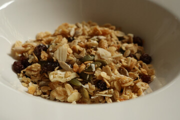Granola cereal in a white bowl, showing healthy breakfast choices and ingredients. Cotswolds countryside, England