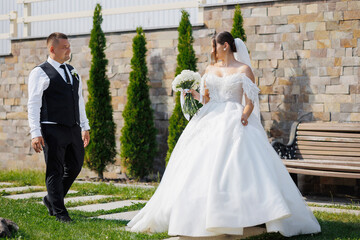 Fototapeta premium Couple exchanges glances during outdoor wedding ceremony with beautiful scenery
