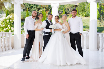 Group of happy people celebrating a wedding at an outdoor venue during the day