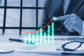 Businessman Pointing at Rising Financial Graph in Office