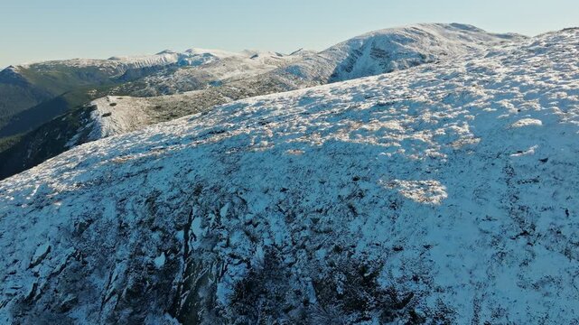 A stunning winter landscape of snowy mountains and serene hillside