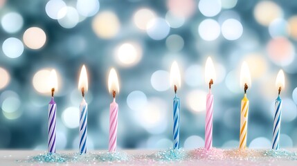 Seven lit birthday candles sparkle with festive bokeh lights.