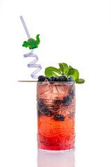 Blackberry cocktail with mint and ice on white background. Vibrant blackberry cocktail with ice, mint leaves, and decorative straw served in tall clear glass.